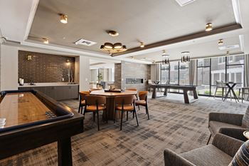 A resident clubhouse with a pool table shuffleboard and a foosball table